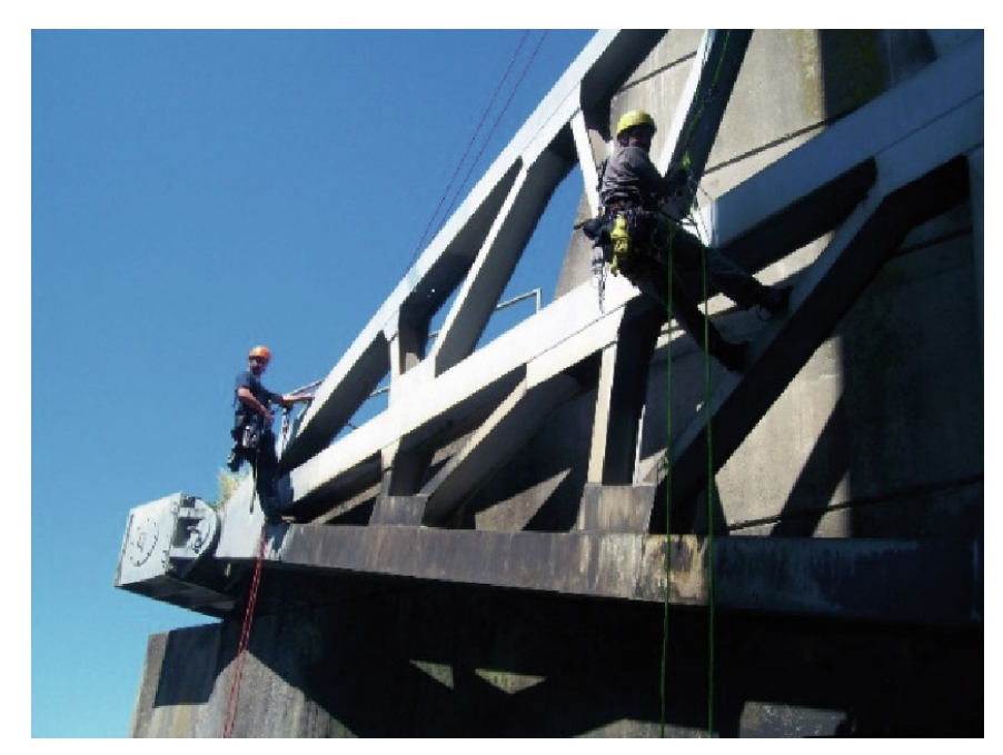 Labor going down bridge for inspection