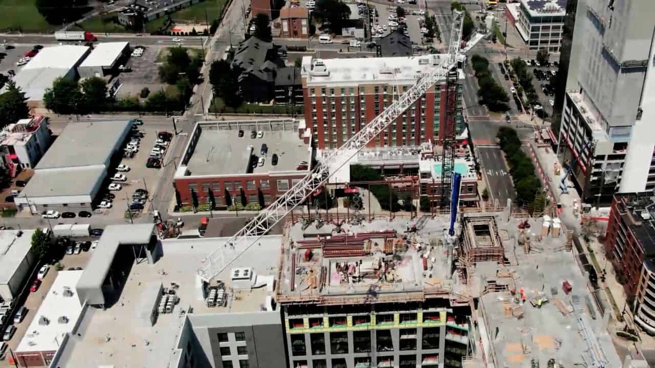 Construction site with crane and building framework in an urban area.