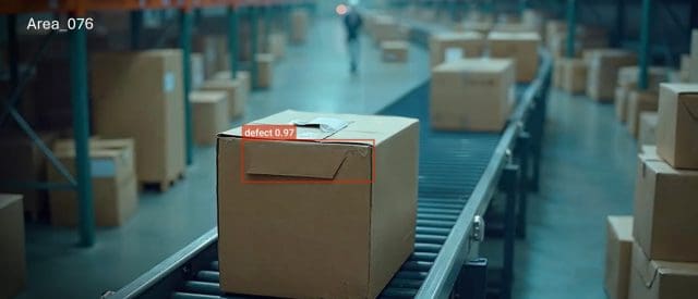 Cardboard box on conveyor belt with defect detection in warehouse automation.