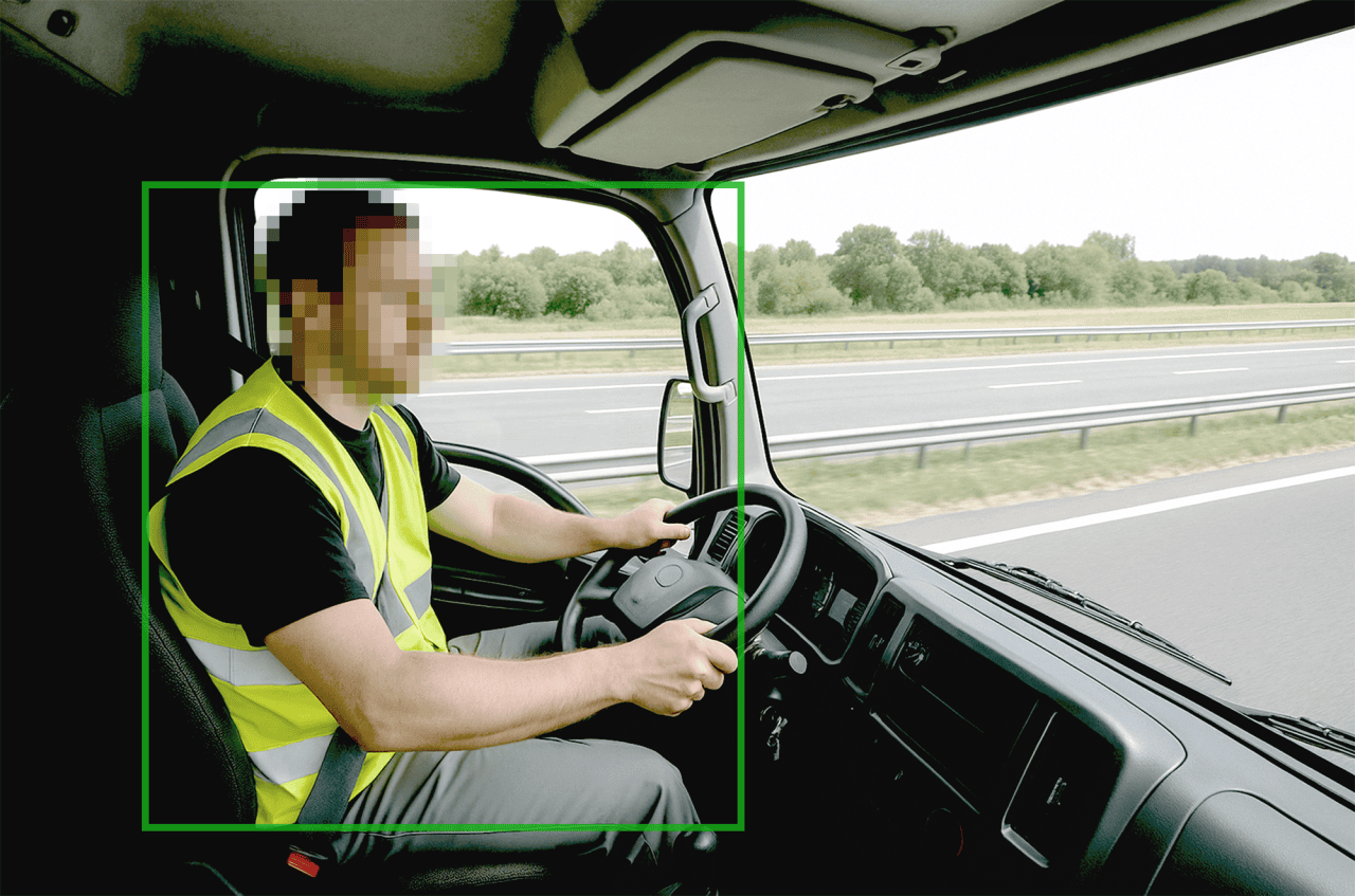 Driver monitoring system assessing a commercial truck driver on the highway.